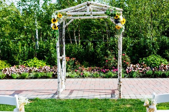 yellow ceremony arch for blue yellow rustic country wedding